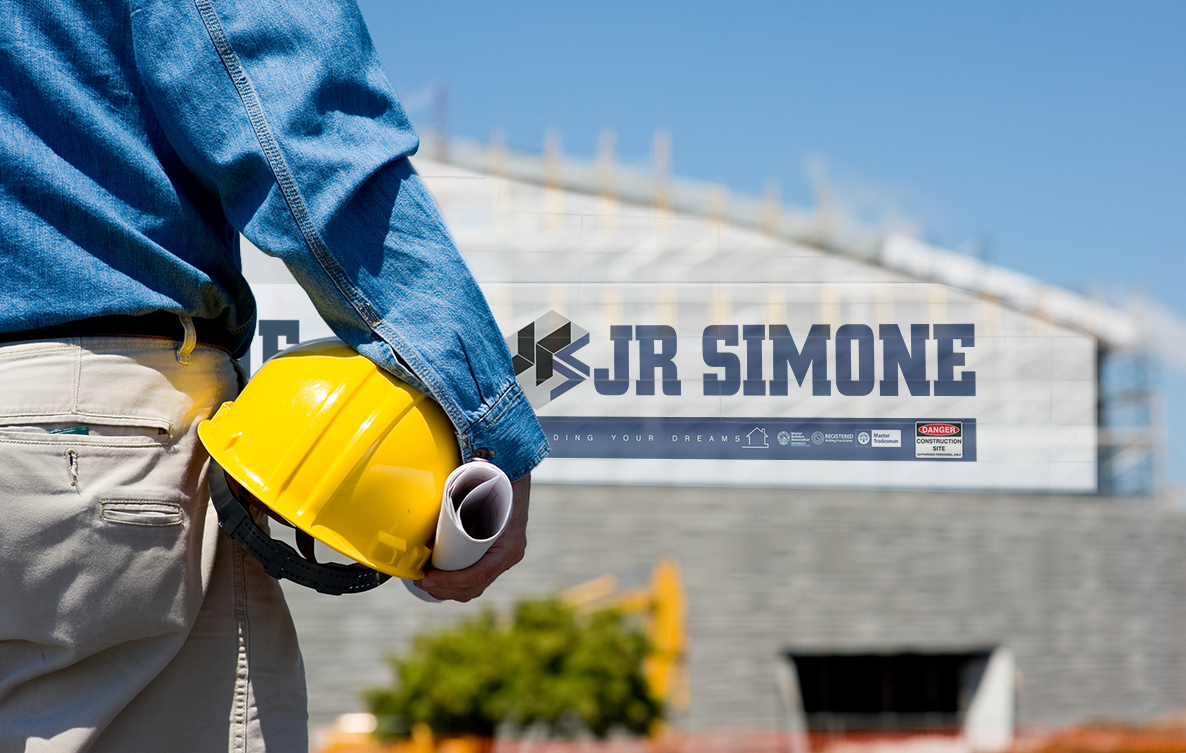 Construction worker looking at the printed scaffolding mesh installed on a building wrap site
